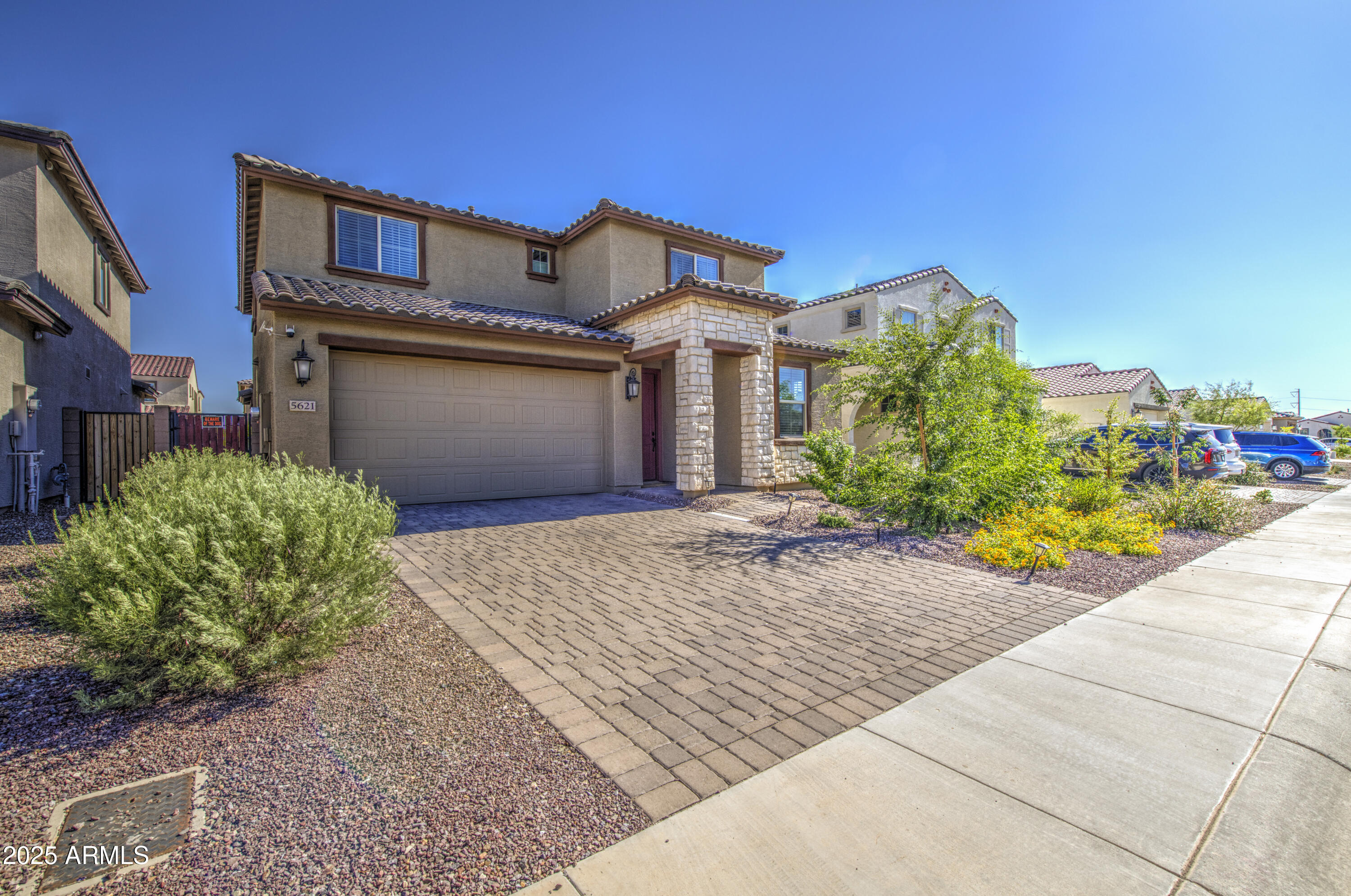 a front view of a house with a yard and a garage