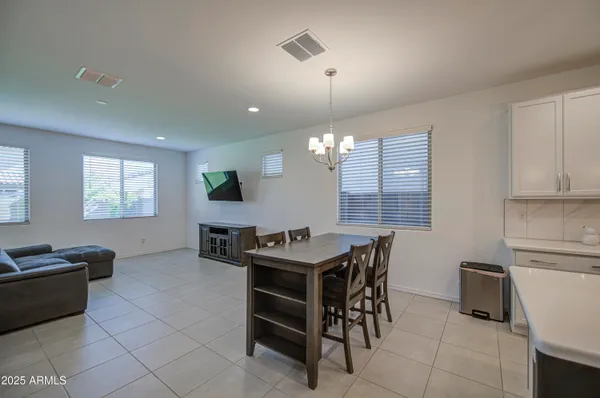 a view of a dining room and kitchen with a table chairs
