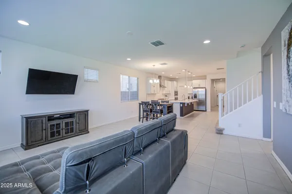 a living room with furniture and kitchen view