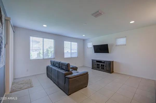 a living room with furniture and kitchen view