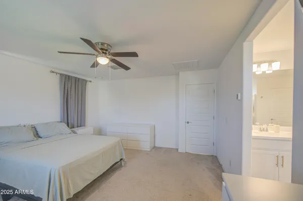 a view of walk in closet with clothes