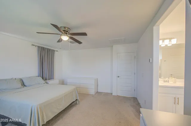 a spacious bathroom with a granite countertop sink mirror and a