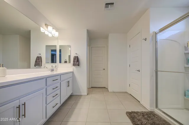 a bathroom with a glass shower door and a glass door
