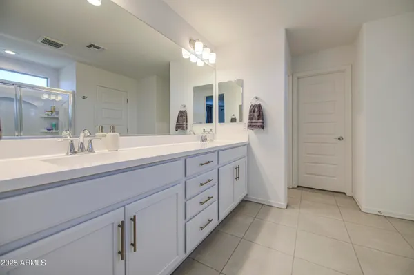 a bathroom with a glass shower door and a glass door