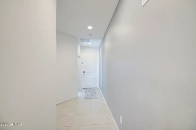 a kitchen with a sink a center island stainless steel appliances and cabinets