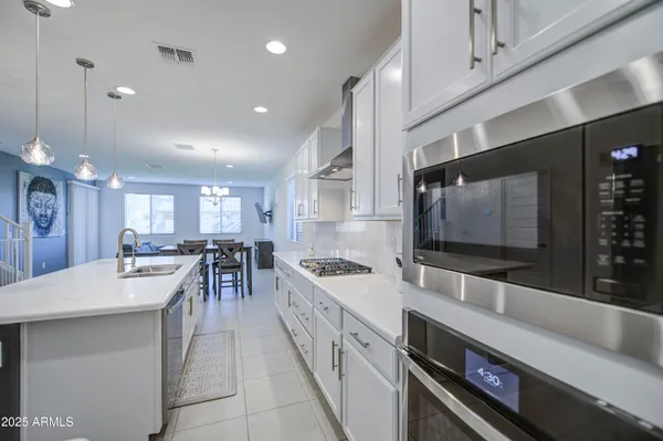 a large kitchen with stainless steel appliances lots of counter space and breakfast area