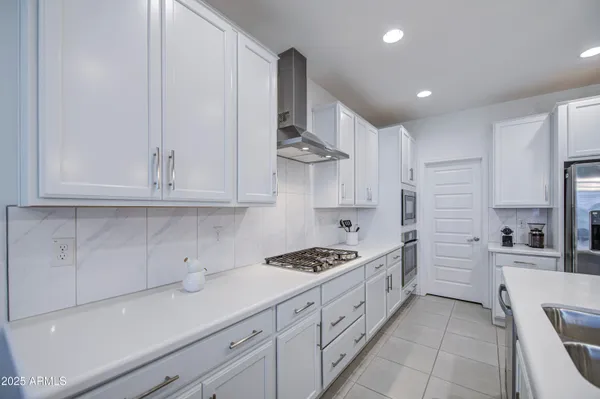 a kitchen with stainless steel appliances granite countertop a sink and cabinets