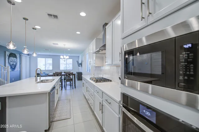 a kitchen with stainless steel appliances granite countertop a sink and cabinets