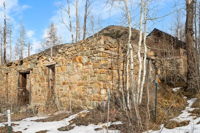 a view of a brick house with a yard
