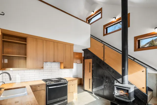 a kitchen with stainless steel appliances granite countertop a stove and a sink