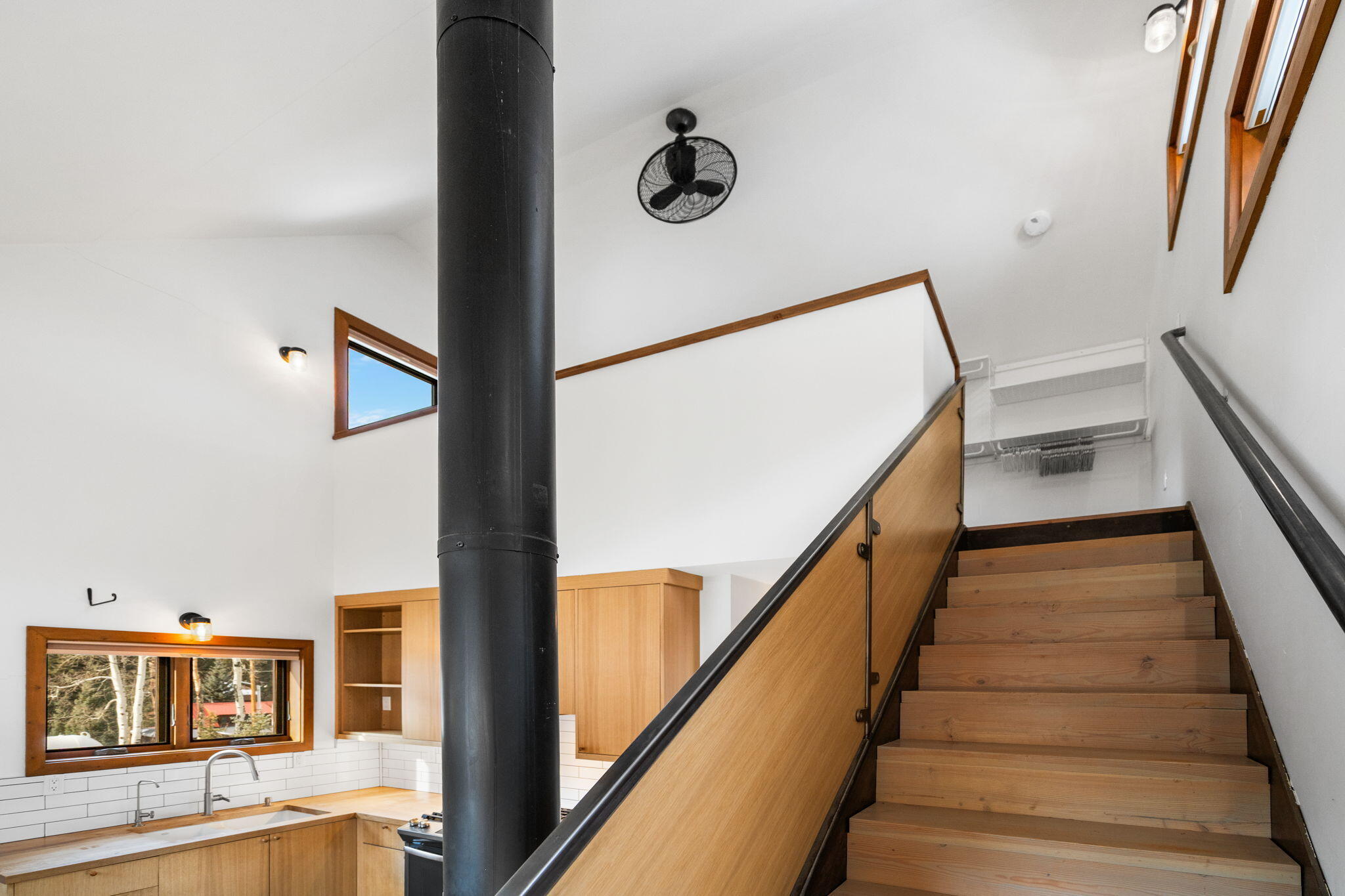 135 West Soda Street Rico, CO 81332 - Photo 8 of 47 a view of staircase with lots of frames on wall and a rug