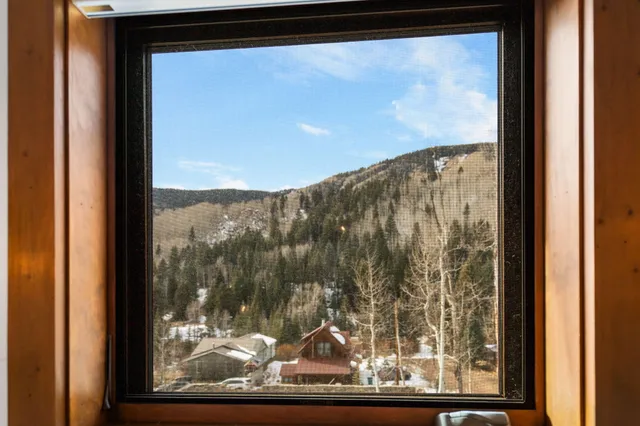 a view of a room with rack on the wall and a window
