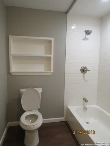 a bathroom with a toilet a sink and bathtub