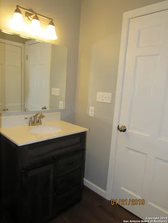 a bathroom with a sink vanity and a mirror