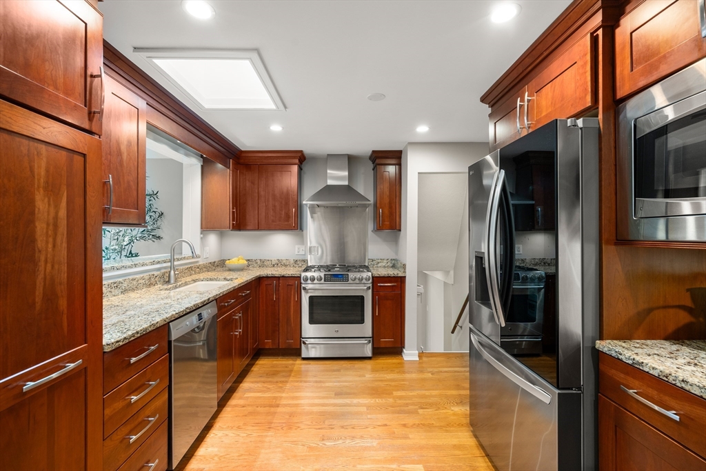 73 Willow Road Sudbury, MA 01776 - Photo 13 of 41 a large kitchen with stainless steel appliances granite countertop a refrigerator a stove and a sink