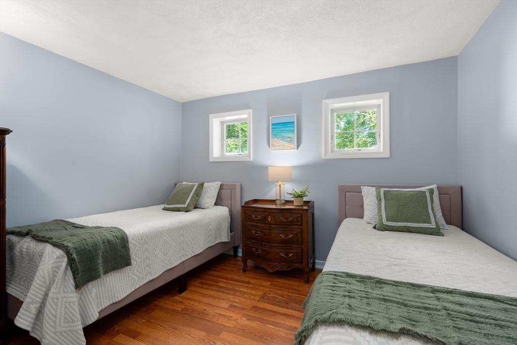 73 Willow Road Sudbury, MA 01776 - Photo 24 of 41 a bedroom with a bed and two windows