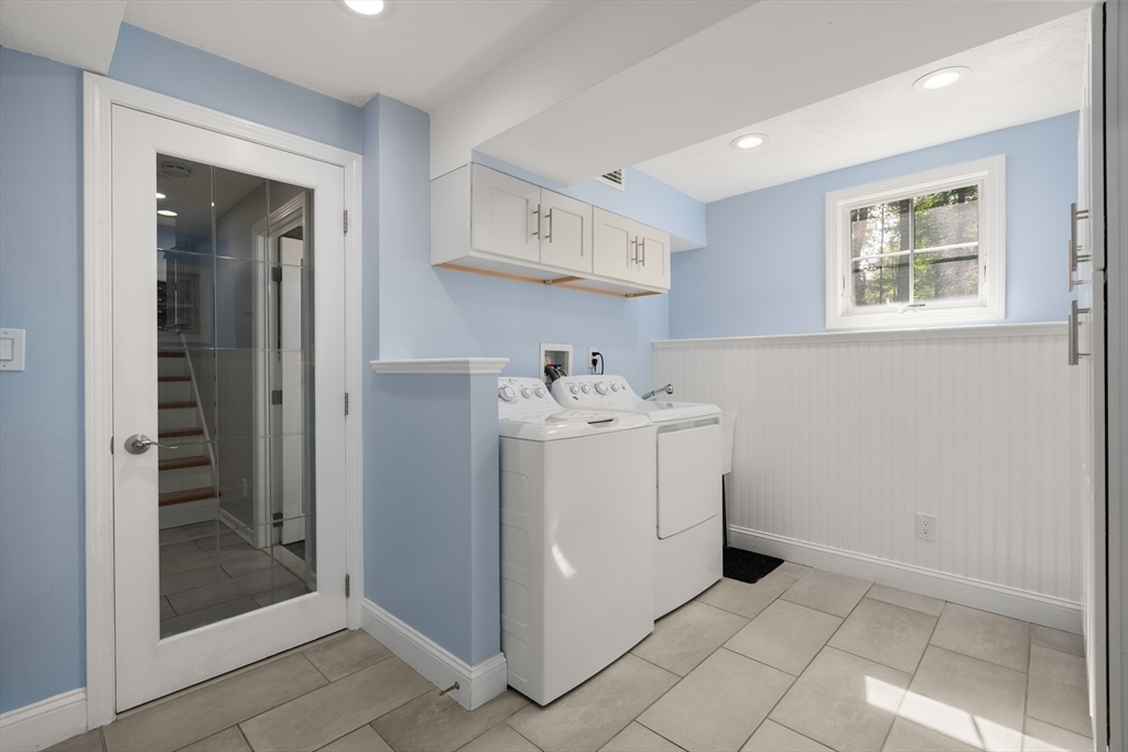 73 Willow Road Sudbury, MA 01776 - Photo 27 of 41 a utility room with cabinets washer and dryer