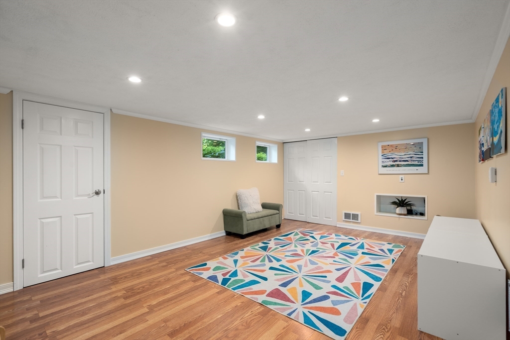 73 Willow Road Sudbury, MA 01776 - Photo 30 of 41 a bedroom with furniture and a wooden floor