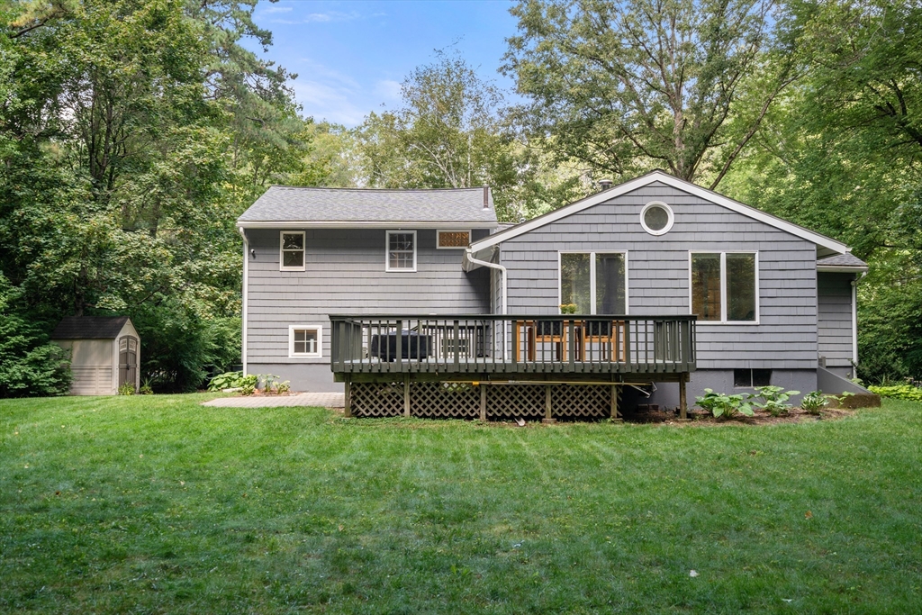 73 Willow Road Sudbury, MA 01776 - Photo 3 of 41 a front view of a house with a garden and deck