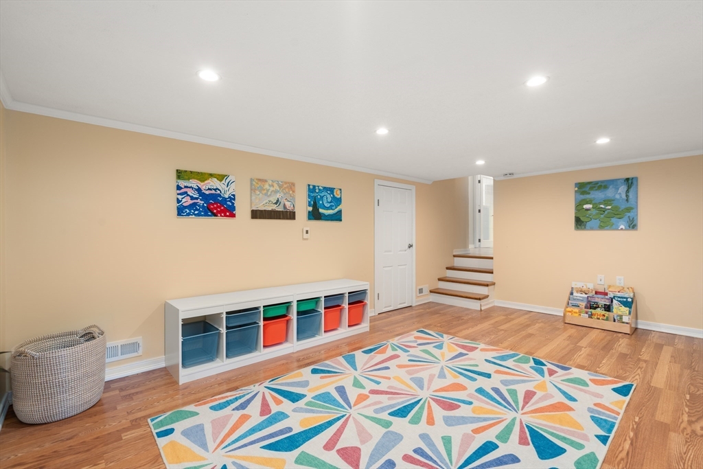 73 Willow Road Sudbury, MA 01776 - Photo 31 of 41 a bedroom with furniture and a wooden floor