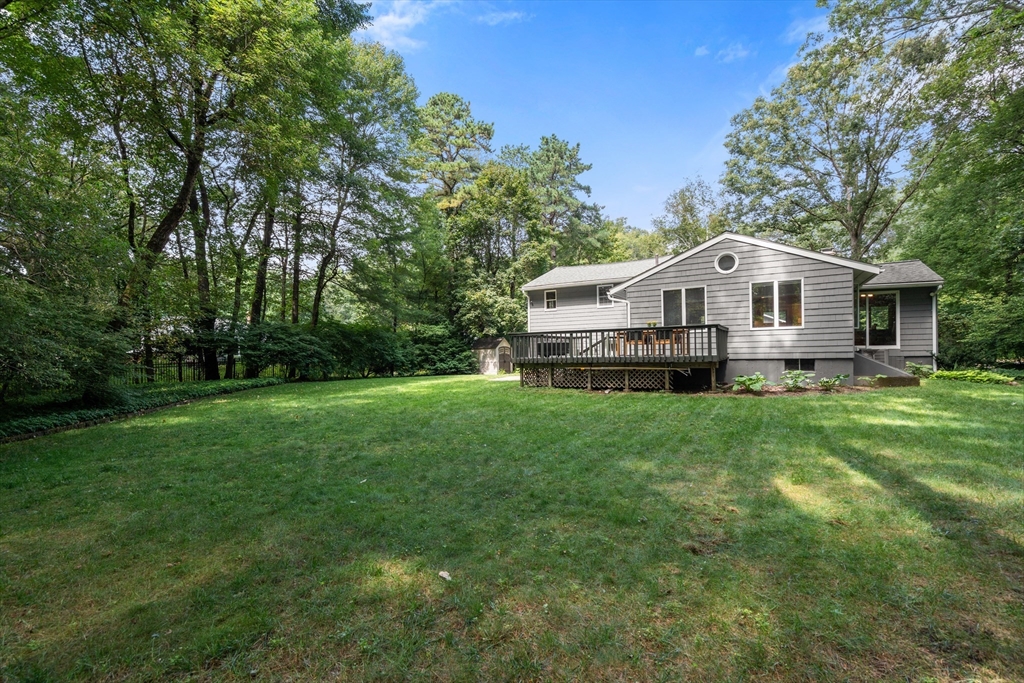 73 Willow Road Sudbury, MA 01776 - Photo 4 of 41 a front view of a house with a yard and trees