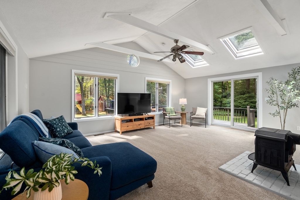 73 Willow Road Sudbury, MA 01776 - Photo 6 of 41 a living room with furniture a flat screen tv and a large window