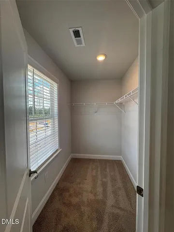 a spacious bathroom with a shower sink and mirror