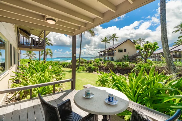 a view of a chairs and table in the balcony