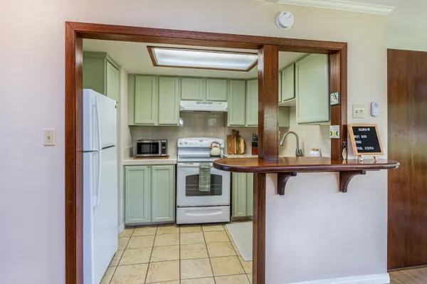 a kitchen with a stove sink and cabinets