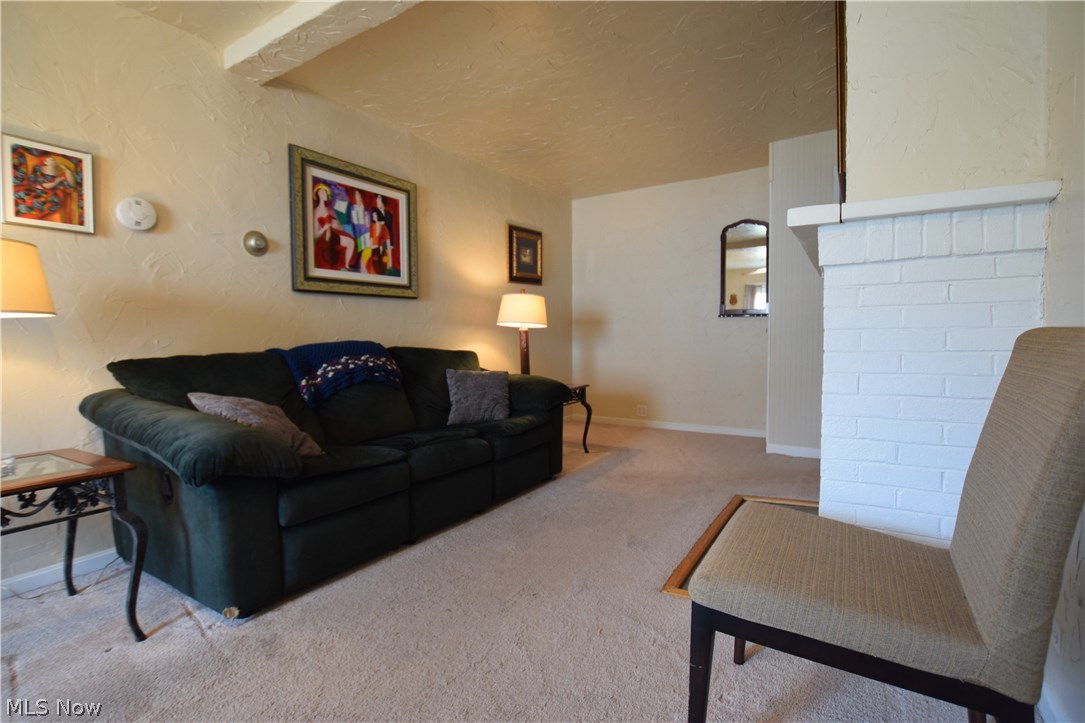 Living Room (10x28) has brick fireplace (now decorative only) and plenty of room for big screen television and seating.