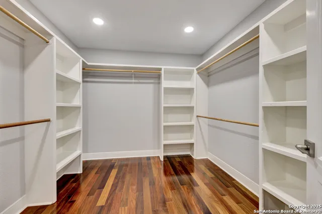 a bedroom with a bed window and flat screen tv