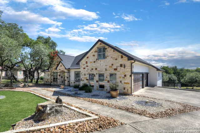 a view of a white house with a yard