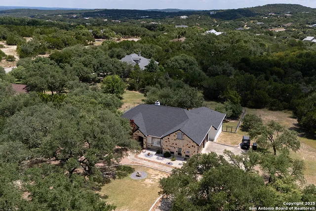 an aerial view of a house with yard