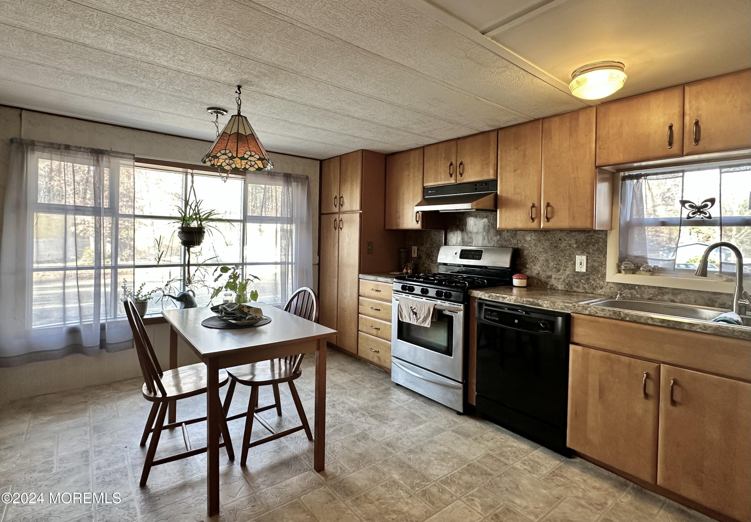 2 Rose Drive Jackson, NJ 08527 - Photo 12 of 20 a kitchen with granite countertop a stove dining table and chairs