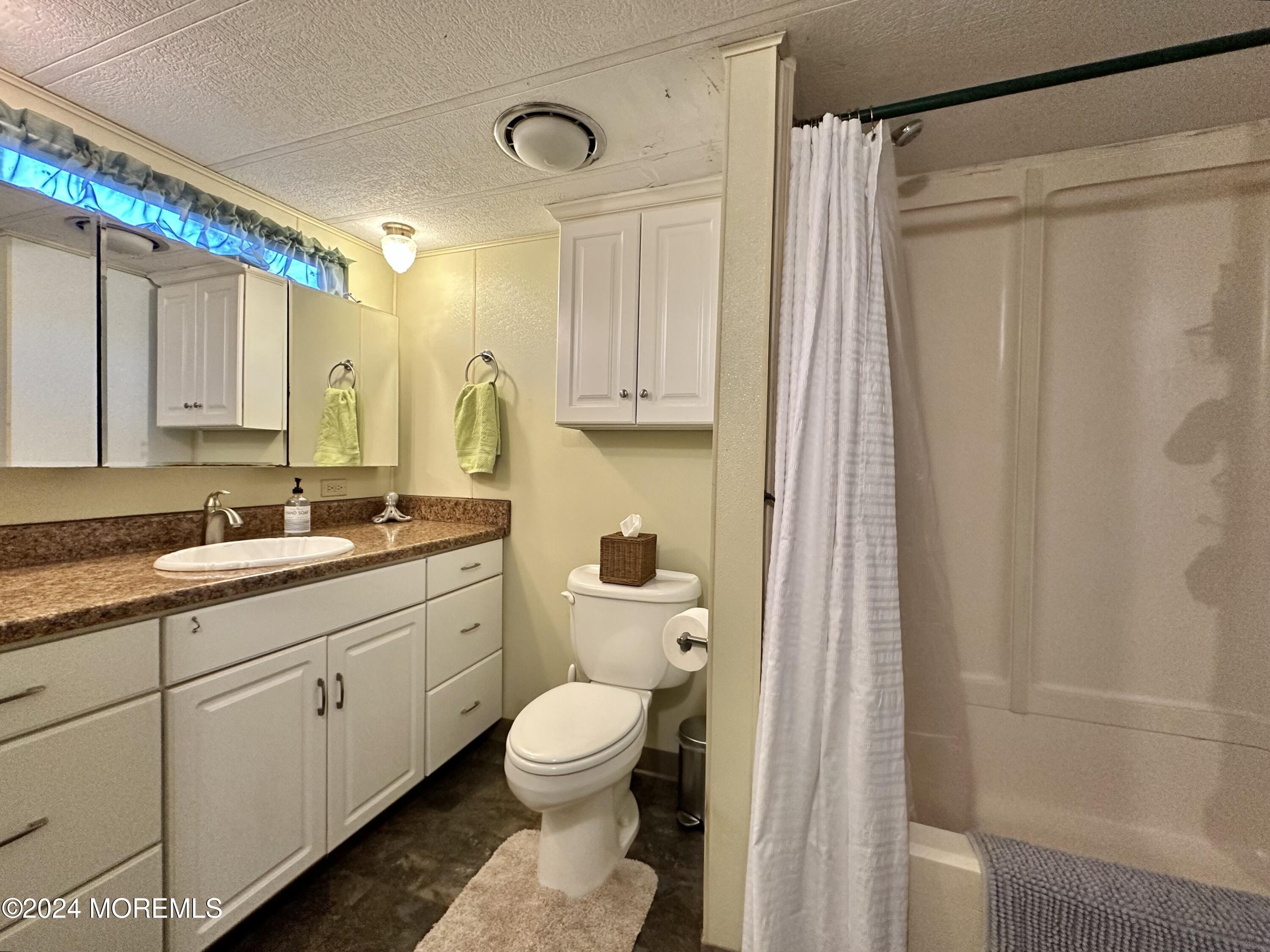 2 Rose Drive Jackson, NJ 08527 - Photo 14 of 20 a bathroom with a granite countertop sink toilet and shower