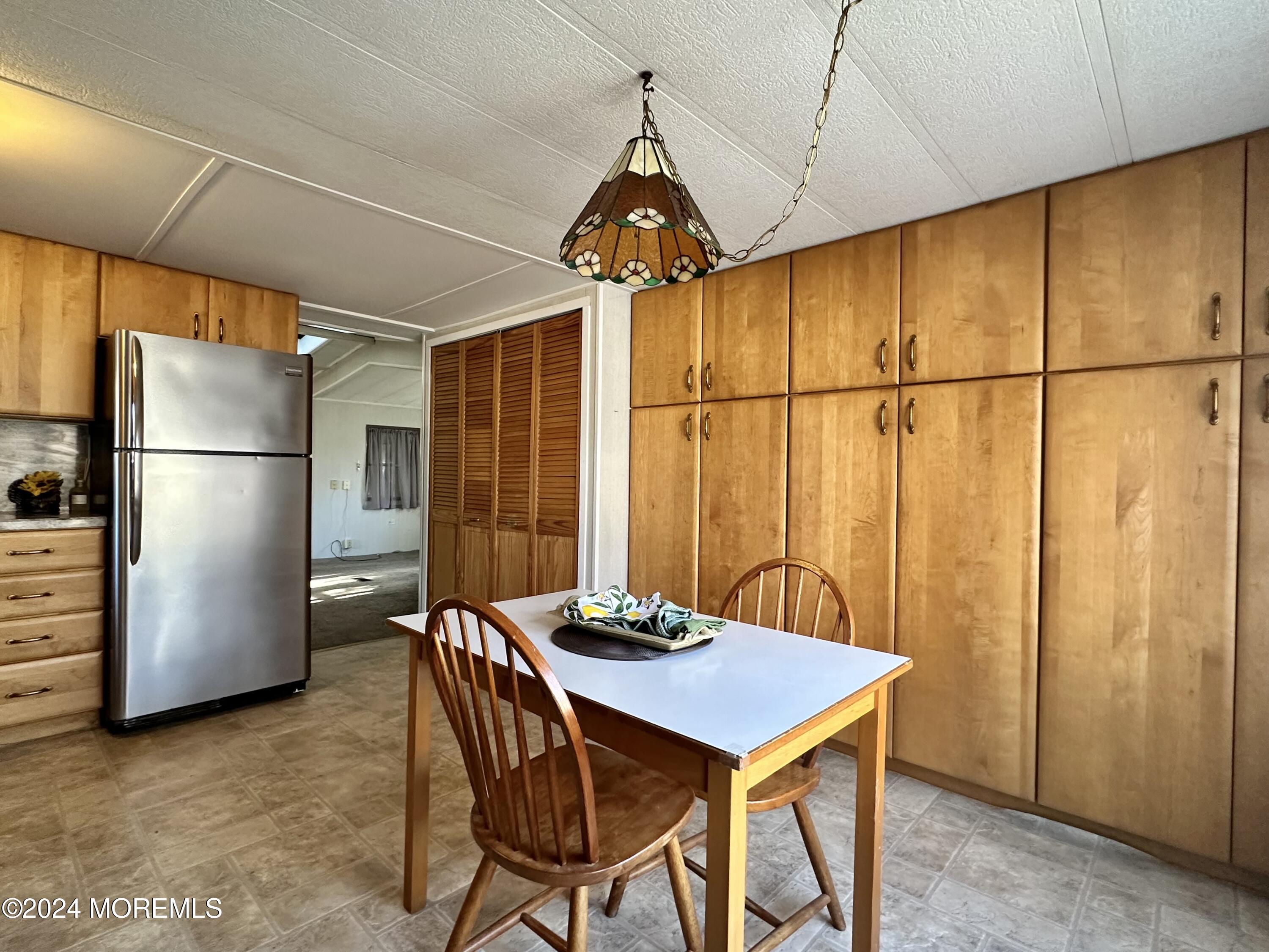 2 Rose Drive Jackson, NJ 08527 - Photo 10 of 20 a kitchen with a refrigerator a table and chairs