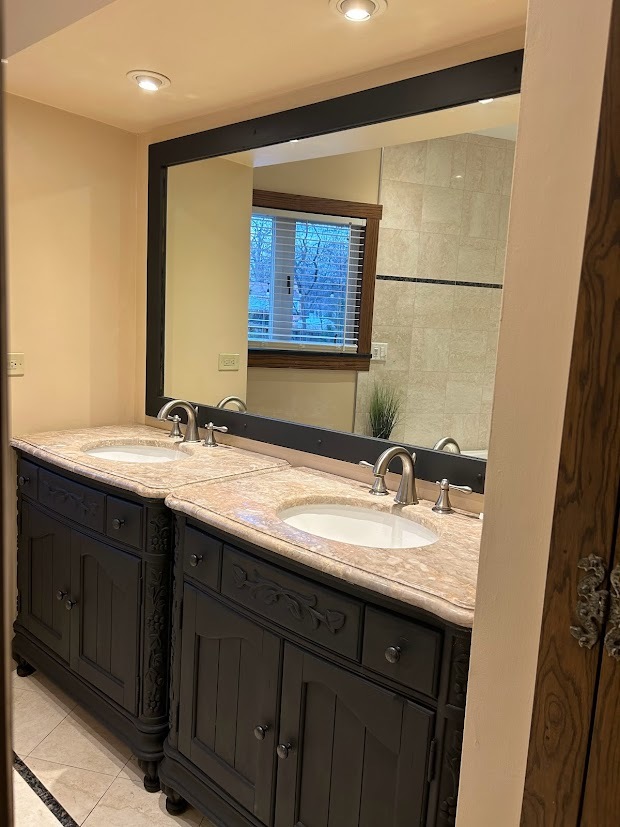 280 Maplewood Road Riverside, IL 60546 - Photo 11 of 30 a bathroom with a granite countertop sink a mirror and a window