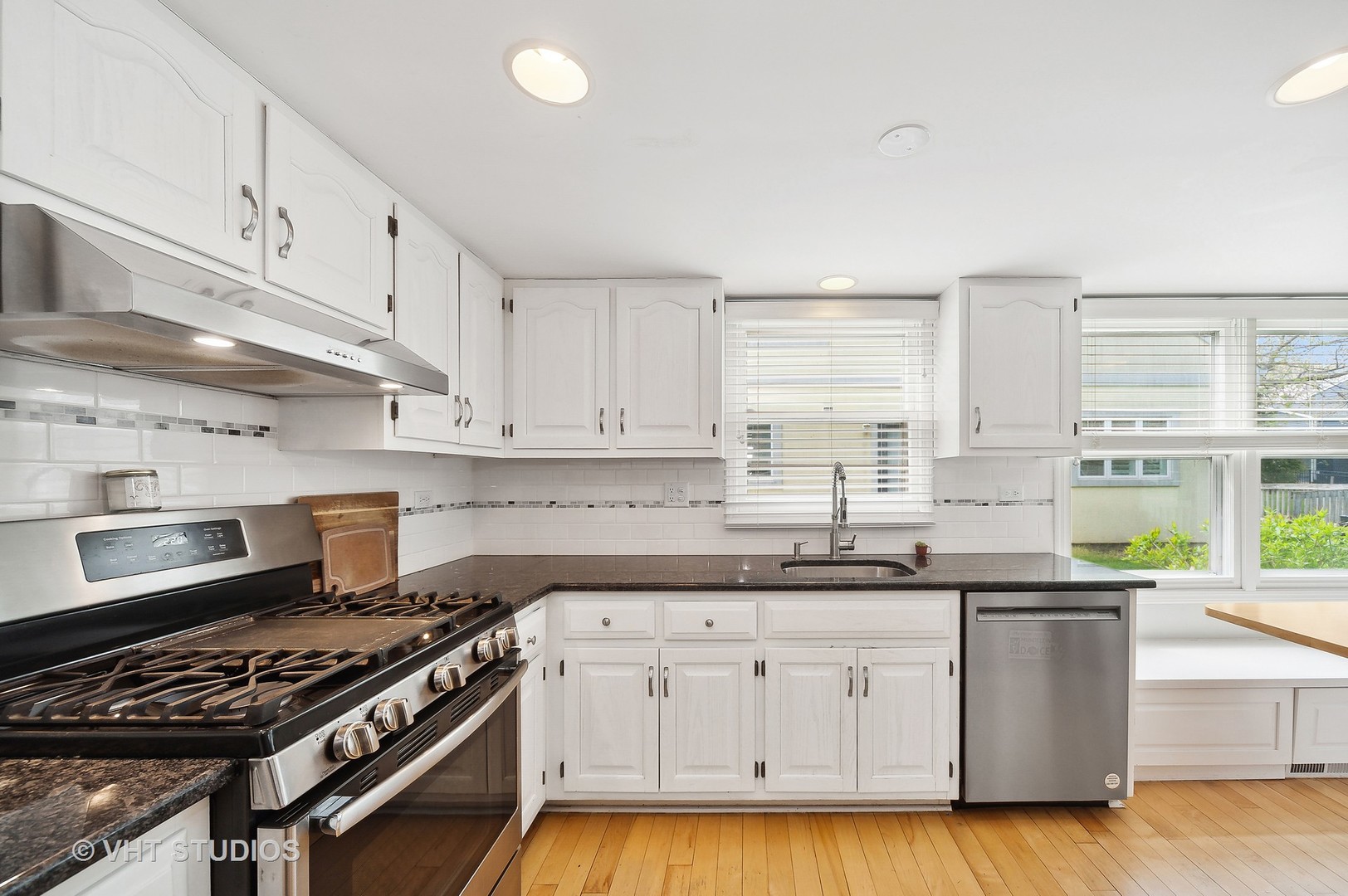 68 West Old Elm Road Lake Forest, IL 60045 - Photo 7 of 19 a kitchen with granite countertop a sink a stove and cabinets