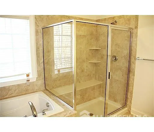 a bathroom with a bathtub and a shower