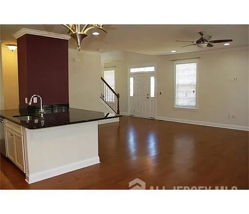 a view of a living room and chandelier
