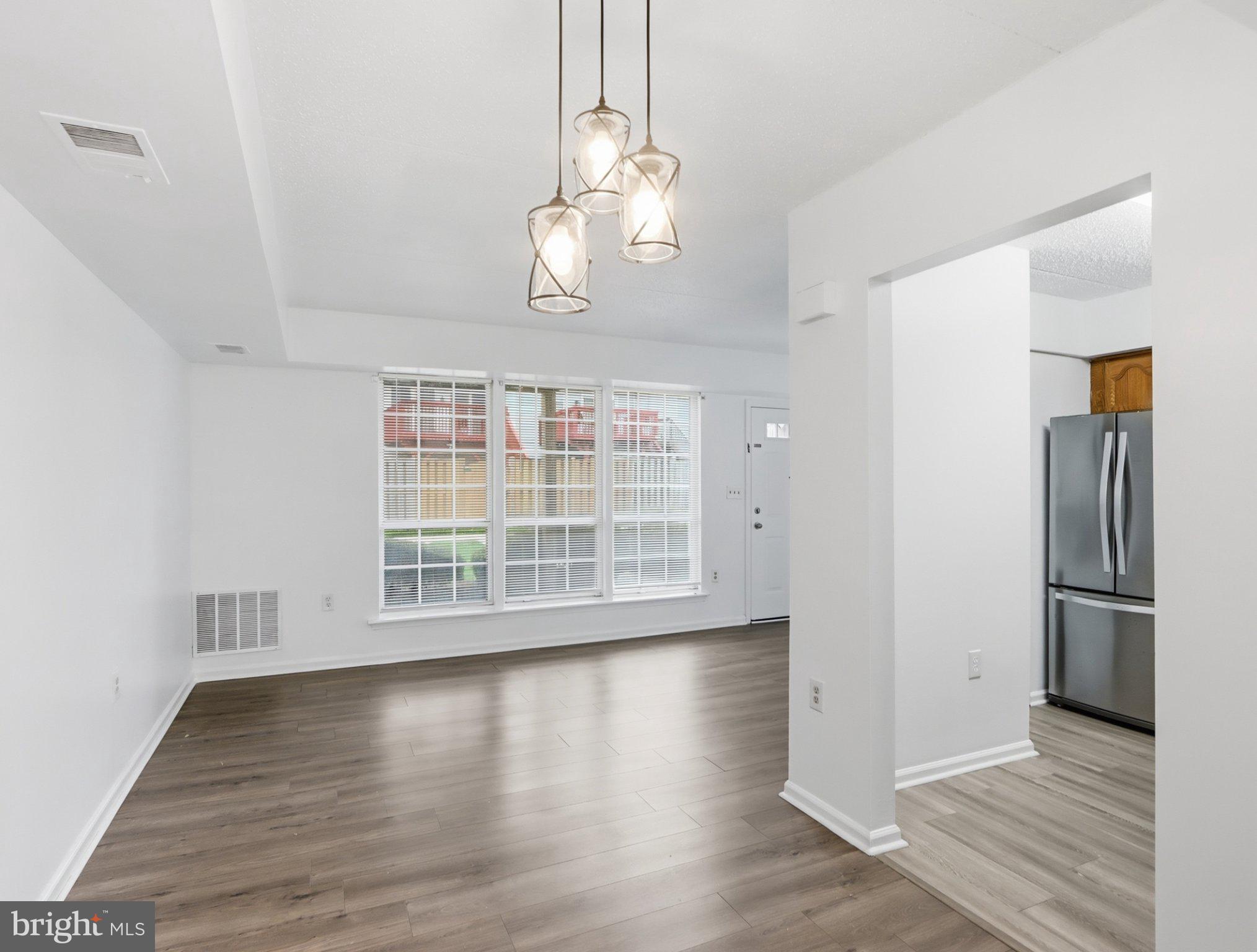 416 Terry Court, Unit A3 Frederick, MD 21701 - Photo 16 of 29 an empty room with wooden floor and windows
