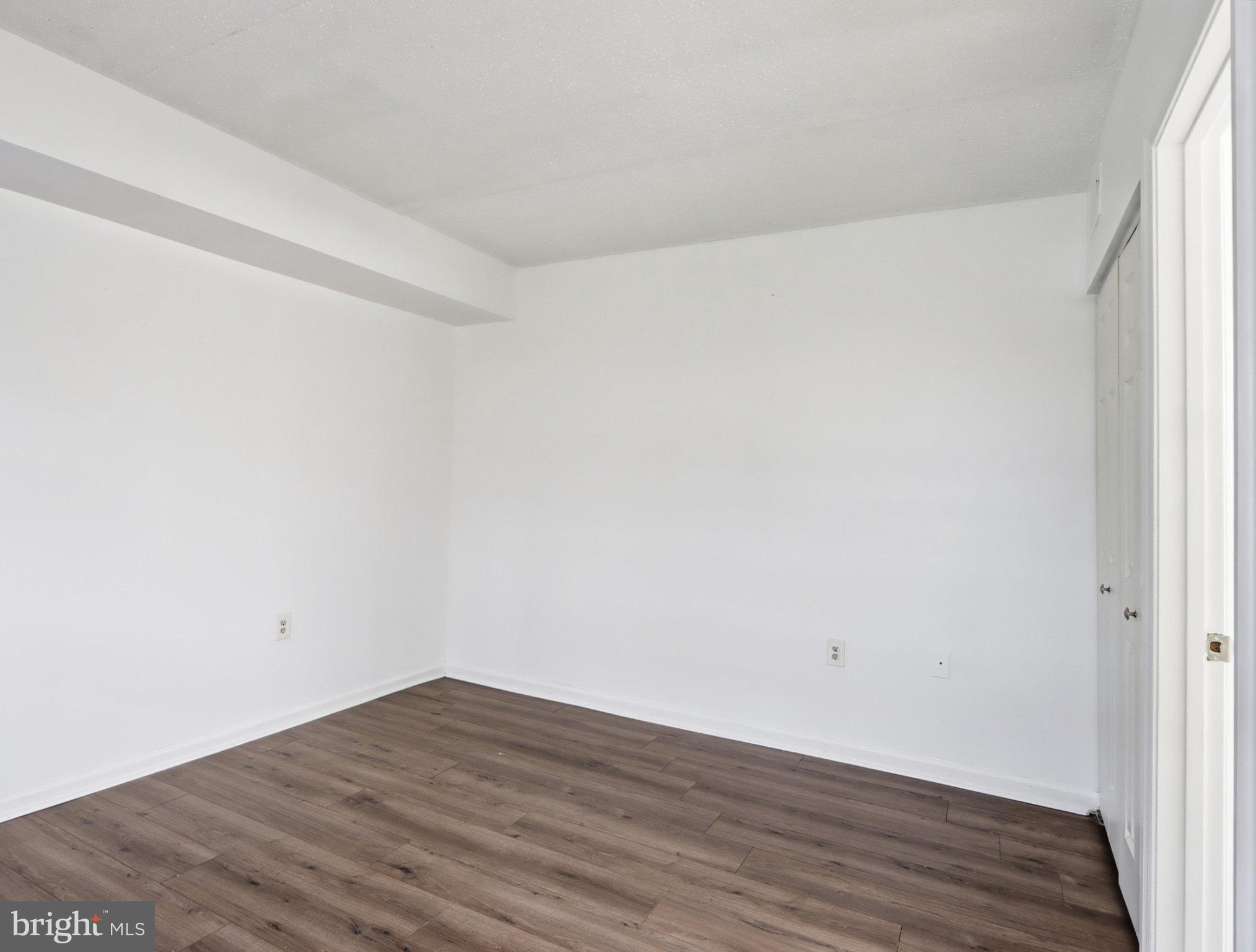 416 Terry Court, Unit A3 Frederick, MD 21701 - Photo 20 of 29 a view of an empty room with wooden floor