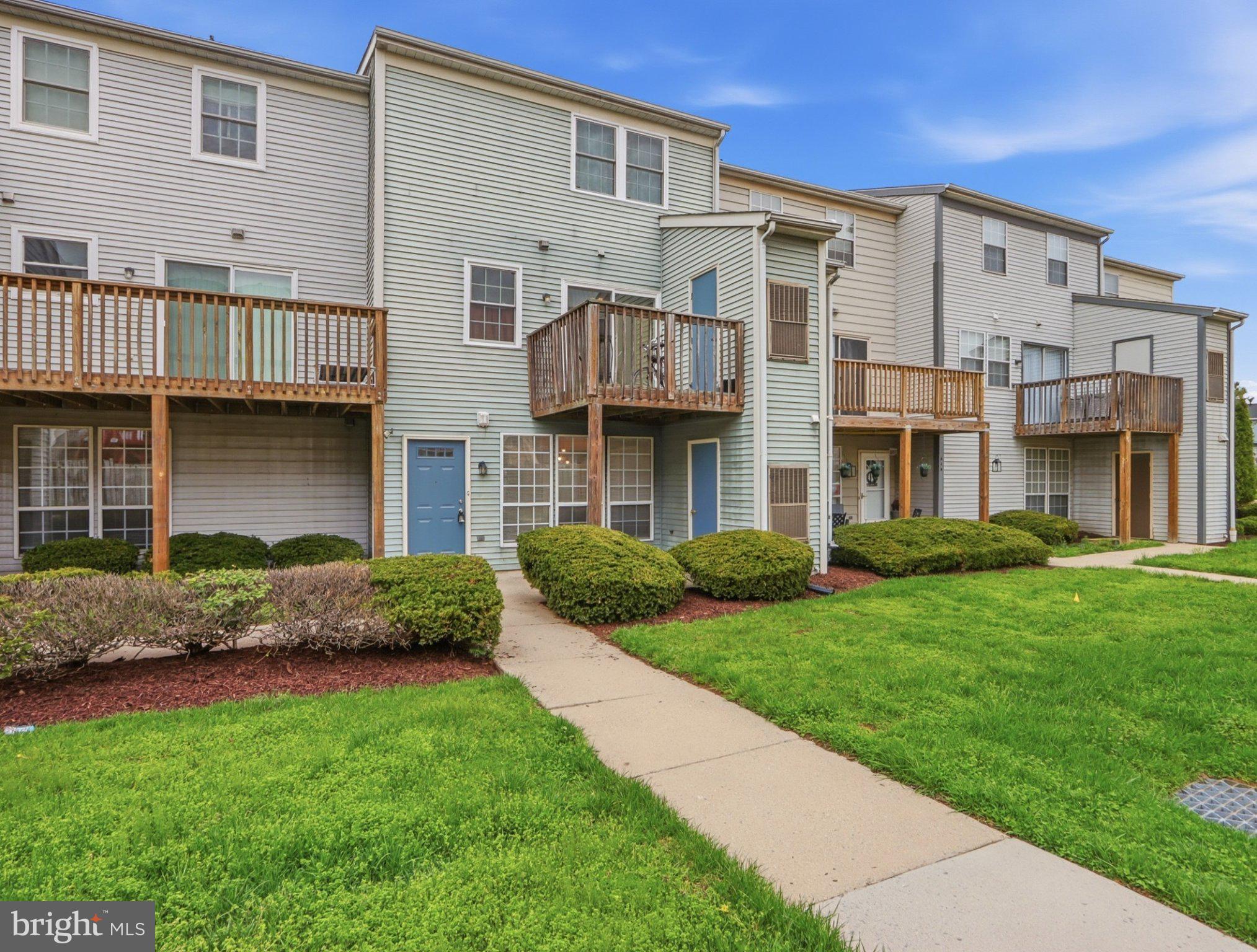 416 Terry Court, Unit A3 Frederick, MD 21701 - Photo 2 of 29 a front view of a house with a garden