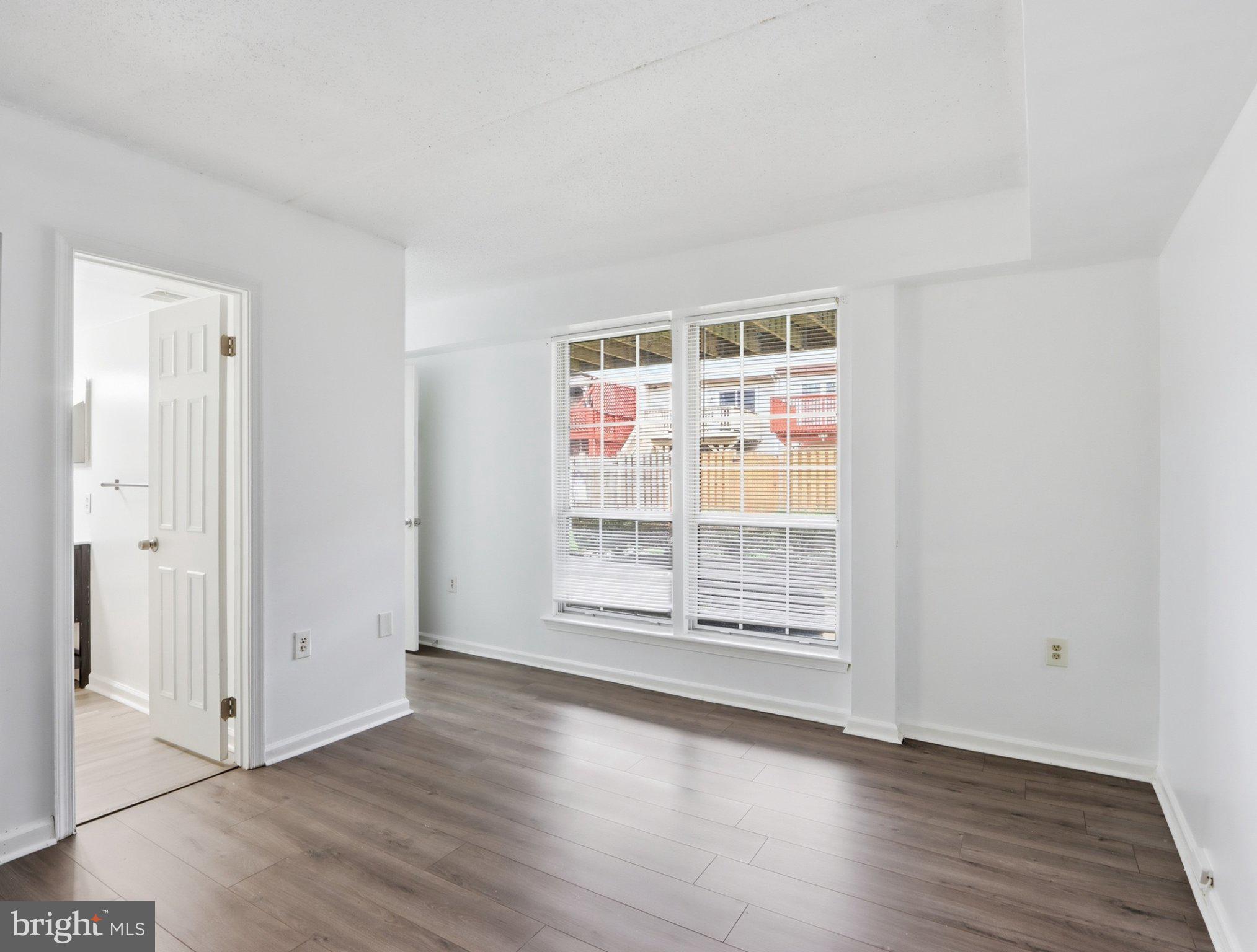 416 Terry Court, Unit A3 Frederick, MD 21701 - Photo 21 of 29 an empty room with wooden floor and windows