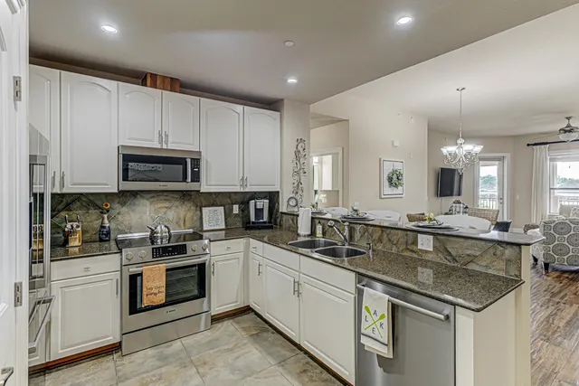 a kitchen with a sink stove and microwave
