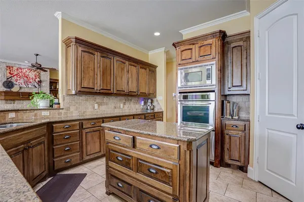 a kitchen with stainless steel appliances granite countertop a refrigerator and a stove top oven