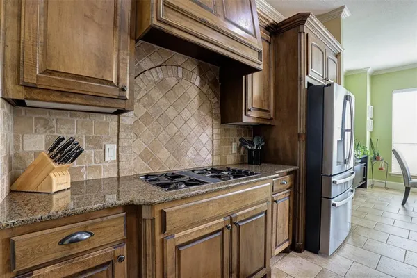 a kitchen with stainless steel appliances granite countertop a stove and a refrigerator
