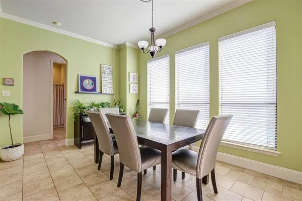 a view of a dining room with furniture and a window
