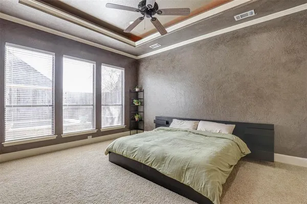 a bedroom with a large bed and a large window