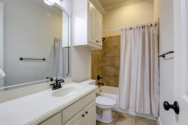 a bathroom with a sink a toilet a mirror and shower